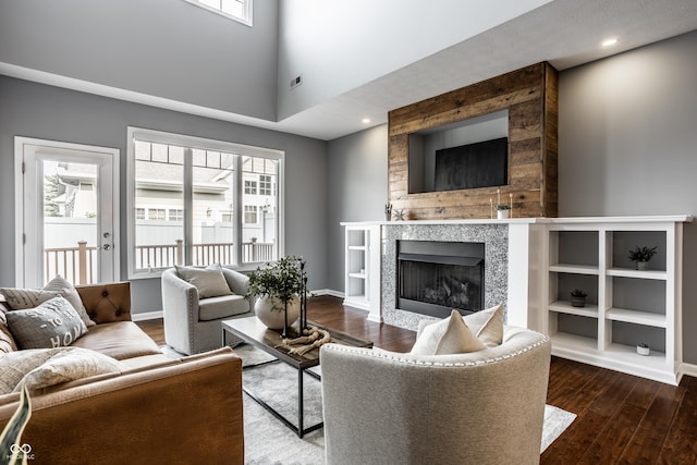 478 Firefly Ln, Carmel, IN 46032 - living area with wood finished floors, a tile fireplace, baseboards, recessed lighting, and a towering ceiling