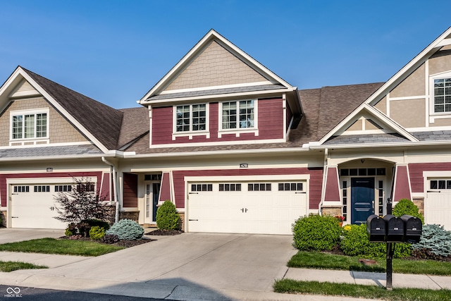478 Firefly Ln, Carmel, IN 46032 - view of front of house featuring concrete driveway, an attached garage, a shingled roof, and stone siding