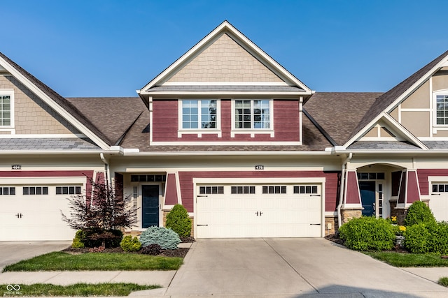 478 Firefly Ln, Carmel, IN 46032 - craftsman-style home with driveway, an attached garage, a shingled roof, and stone siding