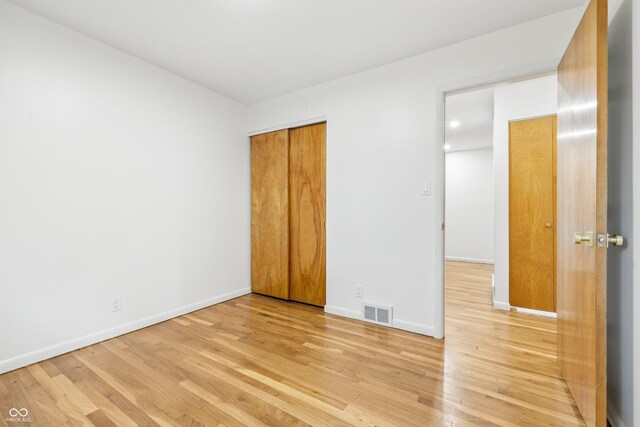 6704 Hoover Rd, Indianapolis, IN 46260 - unfurnished bedroom featuring light wood finished floors, baseboards, and a closet