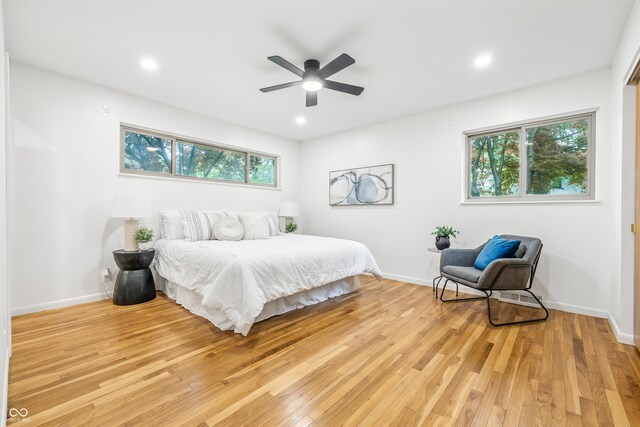 6704 Hoover Rd, Indianapolis, IN 46260 - bedroom featuring multiple windows, light wood finished floors, baseboards, recessed lighting, and a ceiling fan