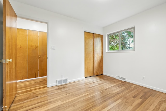 6704 Hoover Rd, Indianapolis, IN 46260 - unfurnished bedroom with light wood finished floors, baseboards, and a closet
