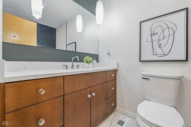 6704 Hoover Rd, Indianapolis, IN 46260 - bathroom featuring toilet, vanity, and baseboards