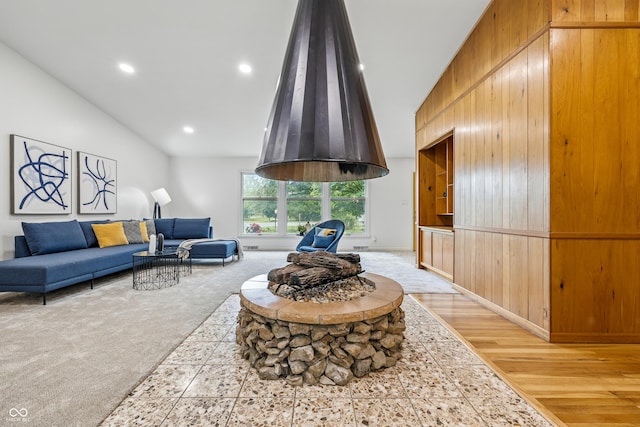 6704 Hoover Rd, Indianapolis, IN 46260 - living area featuring light carpet, wooden walls, lofted ceiling, recessed lighting, and light wood-style flooring