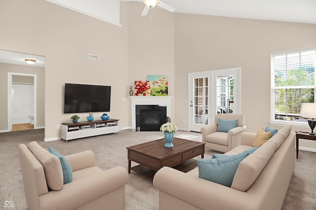 13528 Cuppertino Ln, Carmel, IN 46074 - carpeted living area with high vaulted ceiling, a fireplace with flush hearth, and a ceiling fan