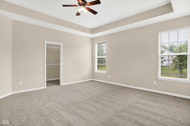 13528 Cuppertino Ln, Carmel, IN 46074 - spare room with carpet, ceiling fan, and a raised ceiling