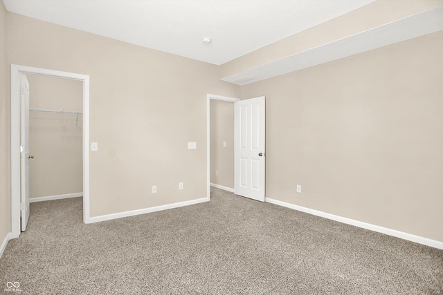 13528 Cuppertino Ln, Carmel, IN 46074 - unfurnished bedroom featuring a walk in closet and carpet flooring