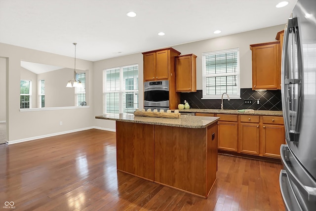 13528 Cuppertino Ln, Carmel, IN 46074 - kitchen featuring appliances with stainless steel finishes, dark wood finished floors, healthy amount of natural light, and recessed lighting