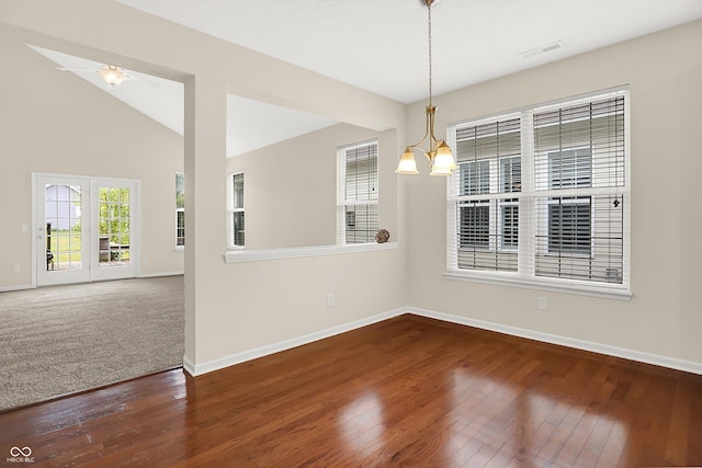 13528 Cuppertino Ln, Carmel, IN 46074 - unfurnished dining area with a chandelier, wood finished floors, and vaulted ceiling