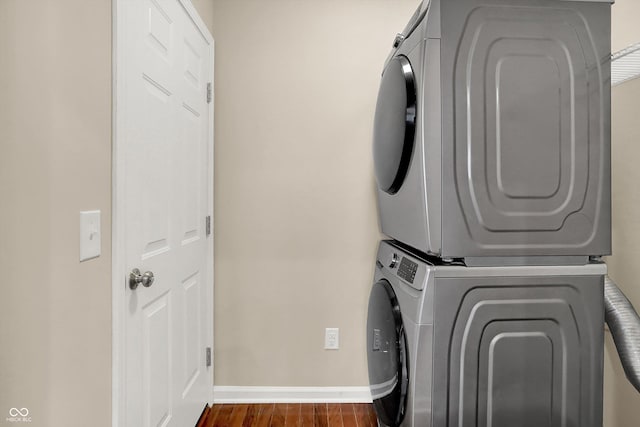 13528 Cuppertino Ln, Carmel, IN 46074 - washroom featuring stacked washing machine and dryer and dark wood-type flooring