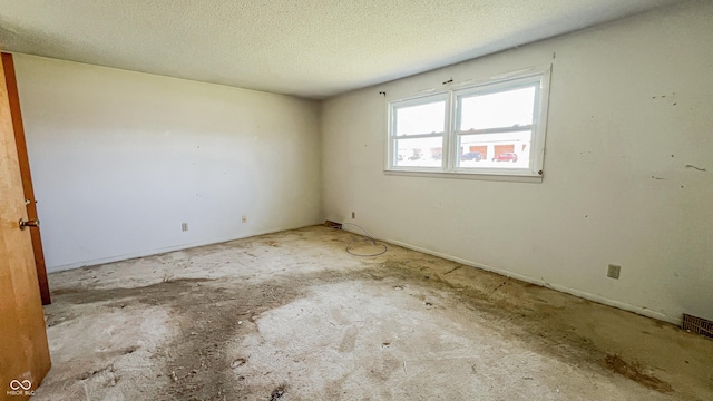 3215 E 10th St, Anderson, IN 46012 - spare room featuring a textured ceiling