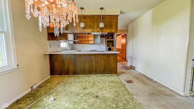 3215 E 10th St, Anderson, IN 46012 - kitchen with baseboards, a peninsula, decorative light fixtures, open shelves, and a chandelier