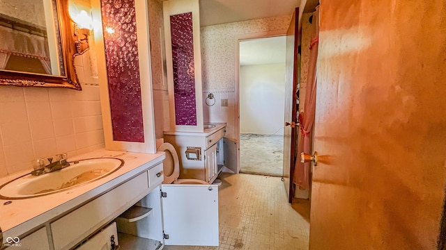 3215 E 10th St, Anderson, IN 46012 - bathroom with wallpapered walls, vanity, and toilet