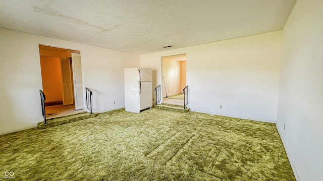 3215 E 10th St, Anderson, IN 46012 - unfurnished room with light colored carpet, baseboards, and a textured ceiling