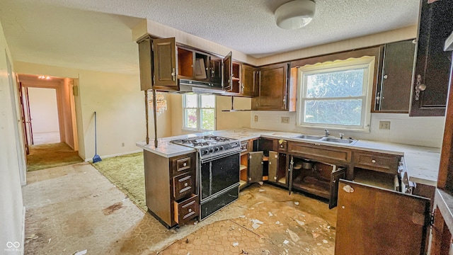 3215 E 10th St, Anderson, IN 46012 - kitchen featuring black range with gas cooktop, a sink, plenty of natural light, a peninsula, and a textured ceiling