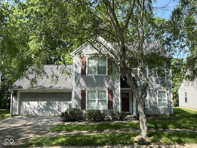 2242 S Sweetbriar Cir, Bloomington, IN 47401 - colonial house featuring a garage and concrete driveway