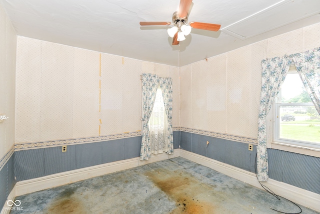 2009 S L St, Elwood, IN 46036 - empty room featuring a ceiling fan, attic access, wallpapered walls, and baseboards