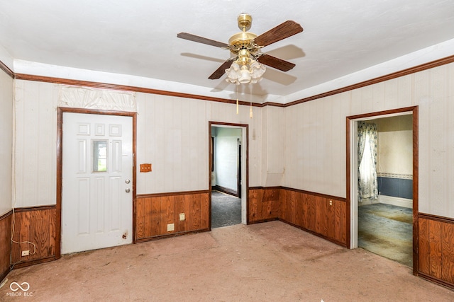 2009 S L St, Elwood, IN 46036 - unfurnished room featuring a wainscoted wall, carpet, wooden walls, and ceiling fan