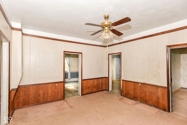 2009 S L St, Elwood, IN 46036 - empty room featuring ceiling fan, wooden walls, ornamental molding, and wainscoting