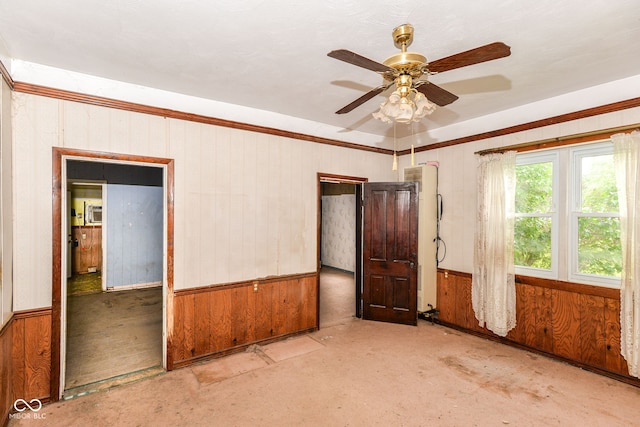 2009 S L St, Elwood, IN 46036 - unfurnished room featuring ceiling fan, wooden walls, unfinished concrete floors, and crown molding
