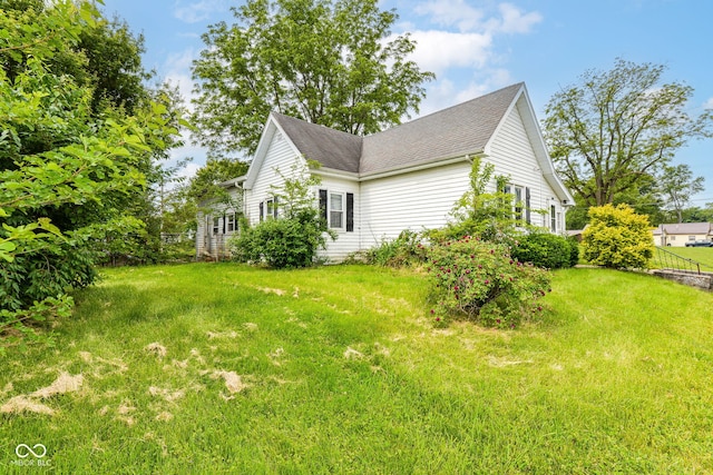 2009 S L St, Elwood, IN 46036 - view of home's exterior featuring roof with shingles and a lawn