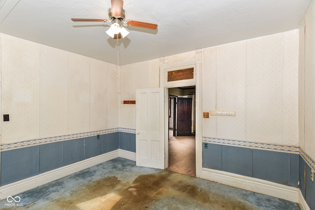 2009 S L St, Elwood, IN 46036 - spare room featuring wallpapered walls, ceiling fan, and a wainscoted wall