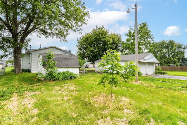 2009 S L St, Elwood, IN 46036 - view of yard featuring a detached garage and an outdoor structure