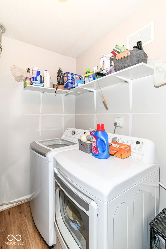 5651 Pine Knoll Blvd, Noblesville, IN 46062 - laundry area featuring washing machine and clothes dryer, light wood-style flooring, and baseboards