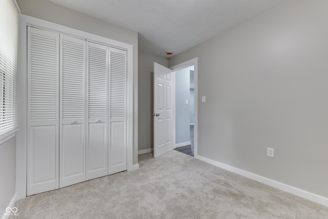 2945 N Denny St, Indianapolis, IN 46218 - unfurnished bedroom with carpet flooring, a closet, a textured ceiling, and baseboards
