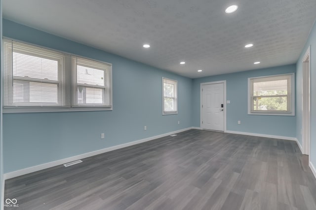 2945 N Denny St, Indianapolis, IN 46218 - empty room featuring healthy amount of natural light, recessed lighting, baseboards, and dark wood finished floors