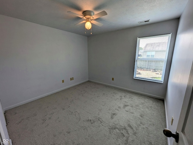581 Grassy Bend Dr, Greenwood, IN 46143 - spare room with ceiling fan, light carpet, baseboards, and a textured ceiling