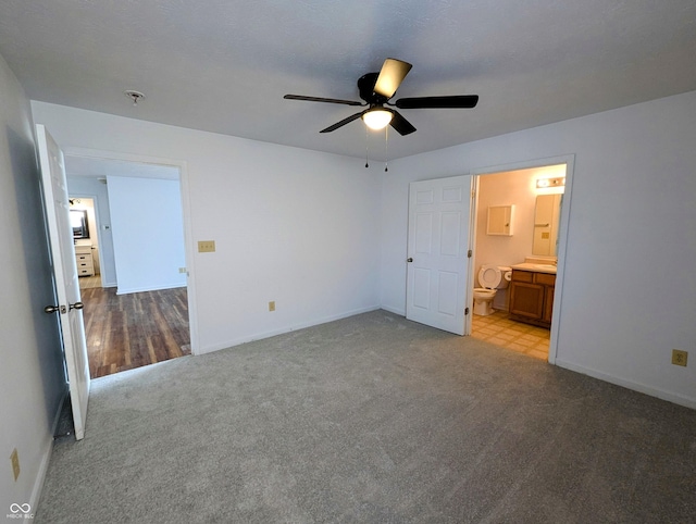 581 Grassy Bend Dr, Greenwood, IN 46143 - unfurnished bedroom with carpet floors, baseboards, connected bathroom, and a ceiling fan