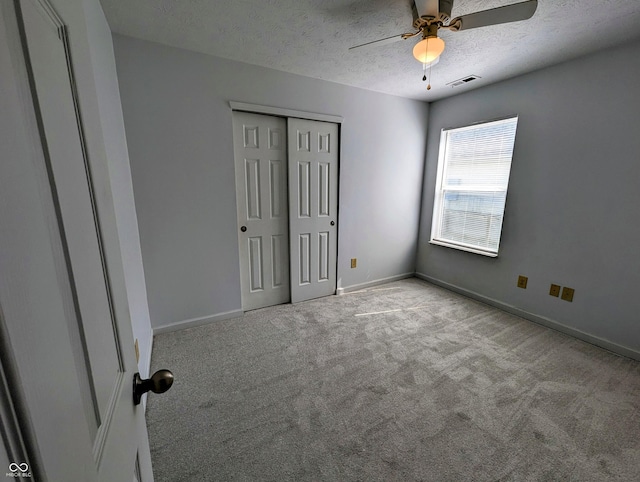 581 Grassy Bend Dr, Greenwood, IN 46143 - unfurnished bedroom with carpet floors, a textured ceiling, baseboards, a closet, and ceiling fan