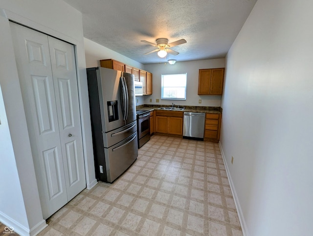 581 Grassy Bend Dr, Greenwood, IN 46143 - kitchen with appliances with stainless steel finishes, a ceiling fan, dark countertops, light flooring, and baseboards