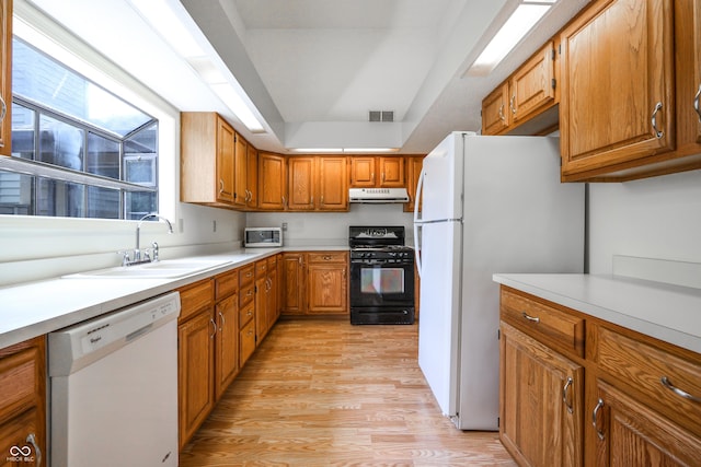 4462 Carya Sq, Columbus, IN 47201 - kitchen featuring white appliances, under cabinet range hood, light wood-style floors, a sink, and light countertops