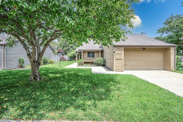 4462 Carya Sq, Columbus, IN 47201 - view of front of home with a garage, a front lawn, driveway, and a shingled roof