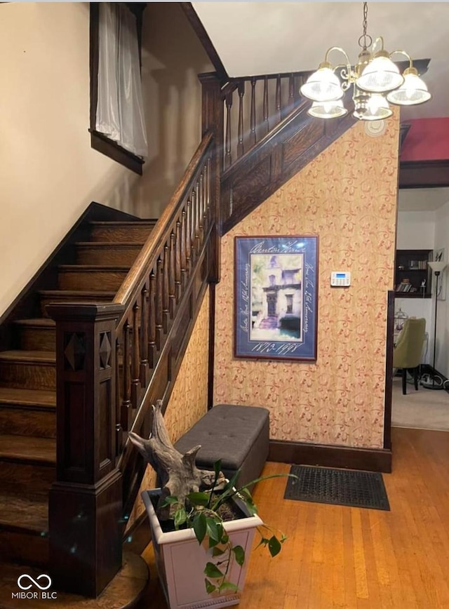 48 N Audubon Rd, Indianapolis, IN 46219 - stairs with a chandelier and hardwood / wood-style flooring