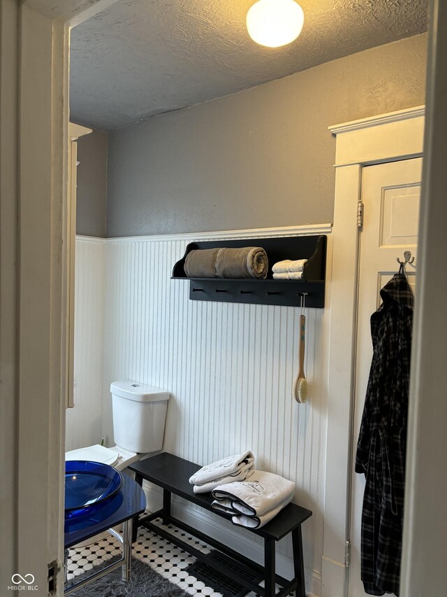 48 N Audubon Rd, Indianapolis, IN 46219 - bathroom with a wainscoted wall and a textured ceiling