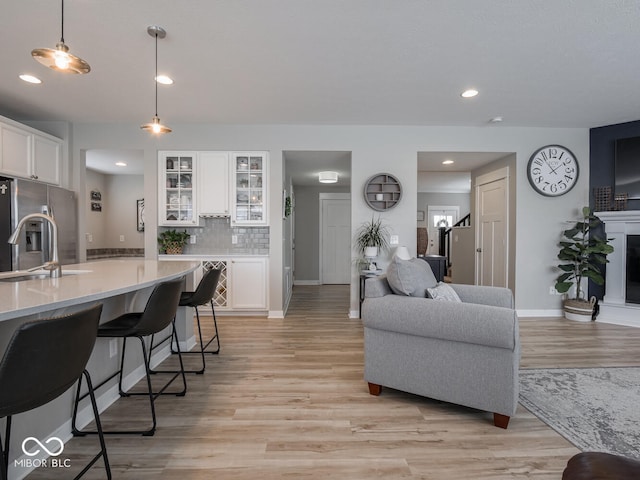 5684 Autumn Trl, Brownsburg, IN 46112 - living room featuring light wood-style floors, a fireplace, baseboards, and recessed lighting