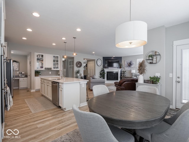 5684 Autumn Trl, Brownsburg, IN 46112 - dining area featuring recessed lighting, light wood-style floors, and a fireplace