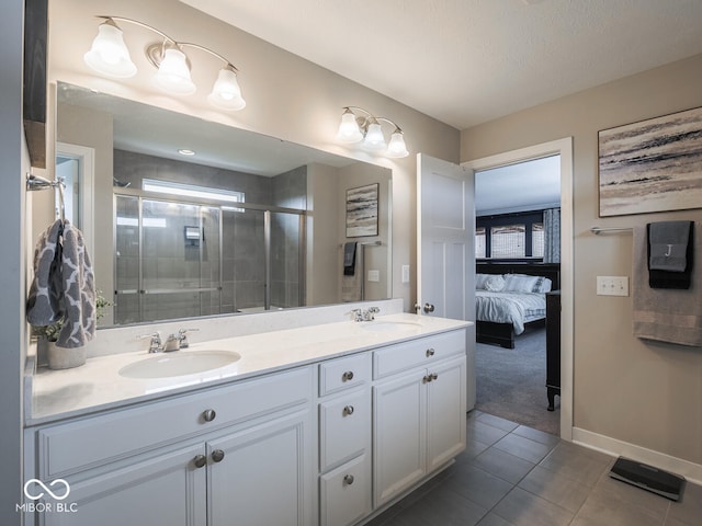 5684 Autumn Trl, Brownsburg, IN 46112 - ensuite bathroom with double vanity, tile patterned flooring, a shower stall, and baseboards