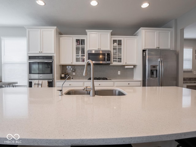 5684 Autumn Trl, Brownsburg, IN 46112 - kitchen featuring appliances with stainless steel finishes, white cabinets, recessed lighting, and light stone countertops