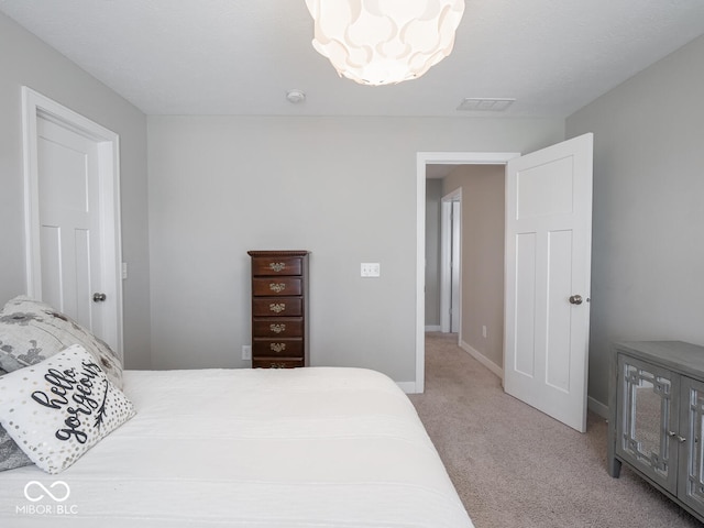 5684 Autumn Trl, Brownsburg, IN 46112 - bedroom with light carpet, a chandelier, and baseboards