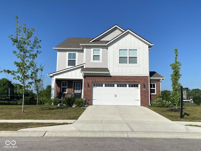 17255 Seaboard Pl, Noblesville, IN 46060 - view of front of house with board and batten siding, concrete driveway, a garage, brick siding, and a front yard