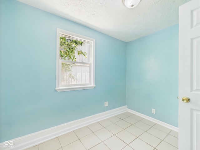 4020 N Mitthoefer Rd, Indianapolis, IN 46235 - empty room featuring a textured ceiling, baseboards, and light tile patterned floors