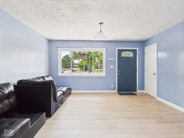4020 N Mitthoefer Rd, Indianapolis, IN 46235 - entryway featuring light wood-style flooring, baseboards, and a textured ceiling