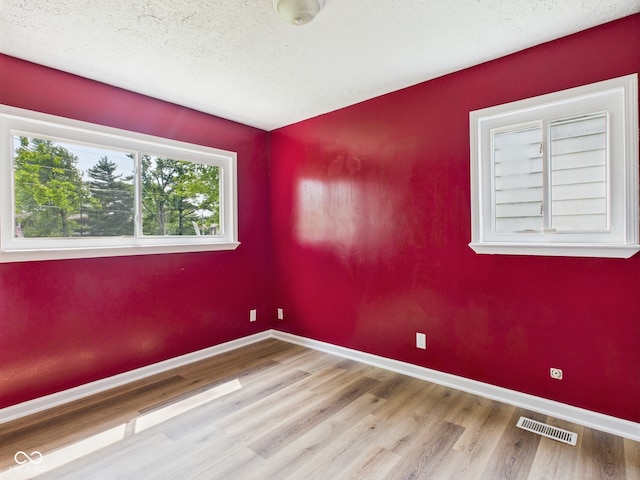 4020 N Mitthoefer Rd, Indianapolis, IN 46235 - unfurnished room with wood finished floors, baseboards, and a textured ceiling
