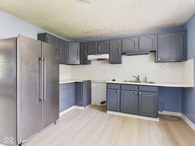 4020 N Mitthoefer Rd, Indianapolis, IN 46235 - kitchen featuring high end fridge, a sink, light wood finished floors, under cabinet range hood, and a textured ceiling