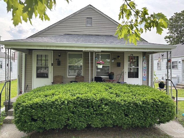 1444 N Denny St, Indianapolis, IN 46201 - view of front facade featuring a porch and roof with shingles
