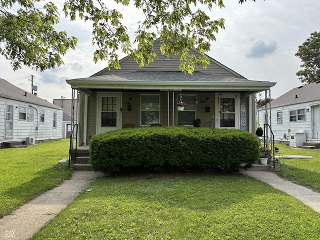 1444 N Denny St, Indianapolis, IN 46201 - view of front of house with covered porch and a front lawn
